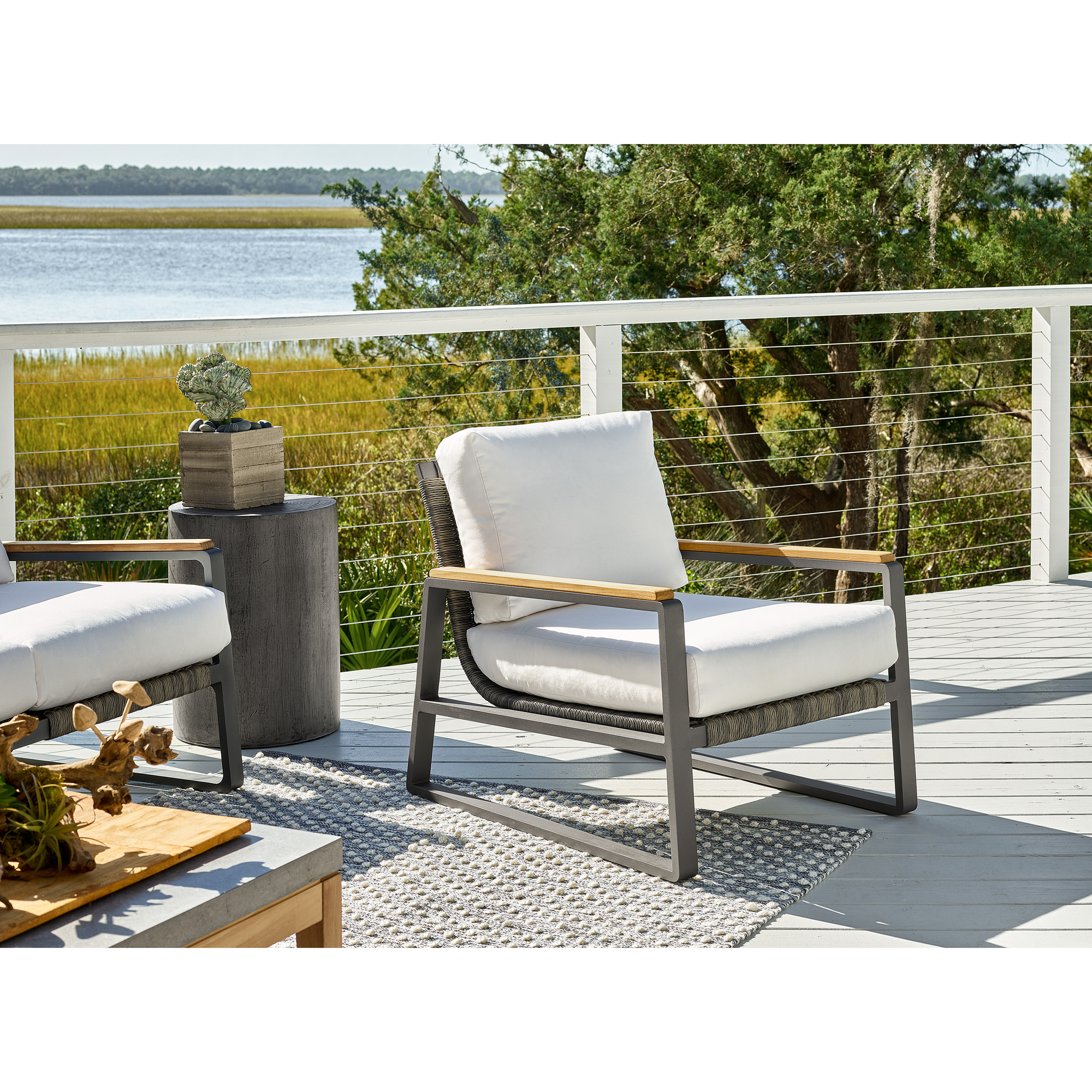 San Clemente club chair with teak arms and brindle rope on a coastal deck