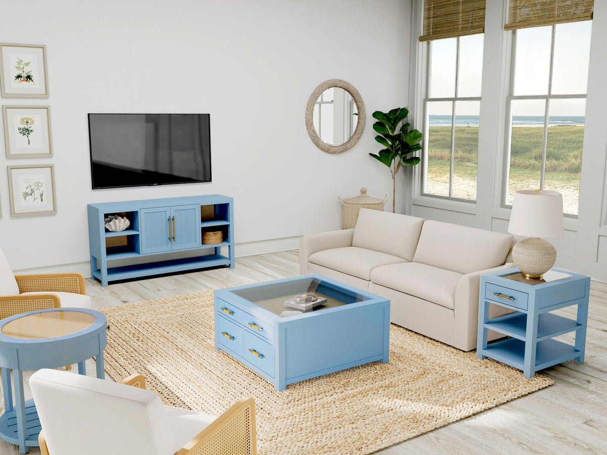 Blue collector coffee table glass display in a coastal room