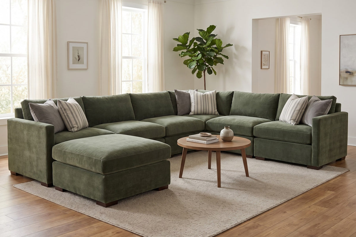 Custom modular sectional in green velvet with a matching ottoman in a bright living room