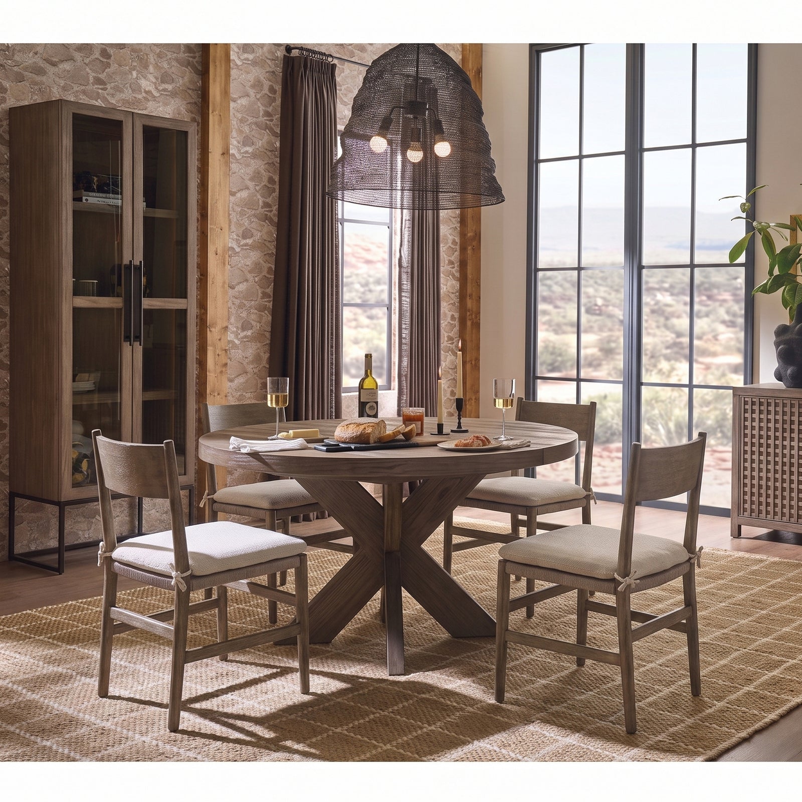 Dwell Latte 5-piece round extendable dining set with X-base table and four wood back side chairs in a sunlit dining room
