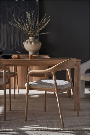 Close-up of an Echo sculpted natural oak arm chair with upholstered seat at the Eden solid oak dining table — view 4