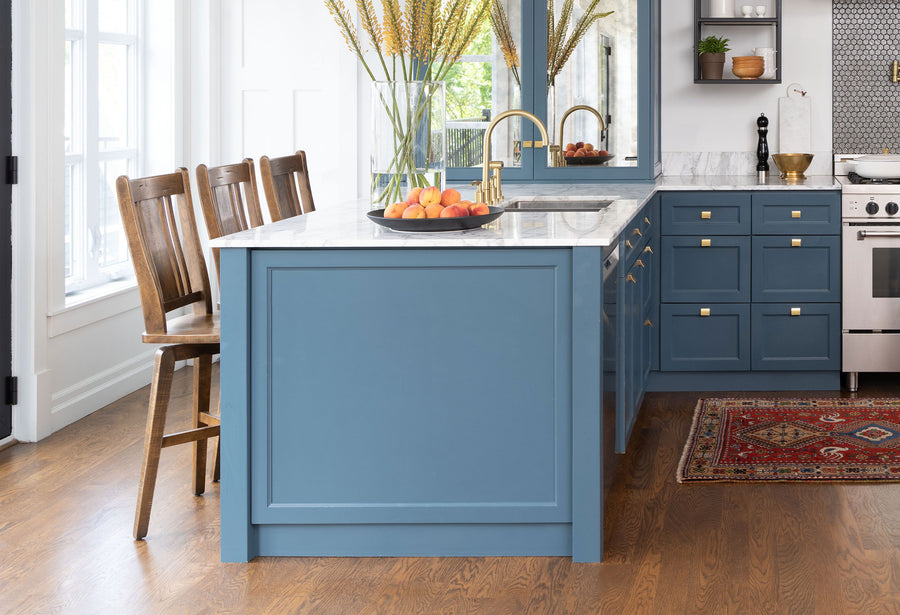 Custom wood counter stools at a blue kitchen island