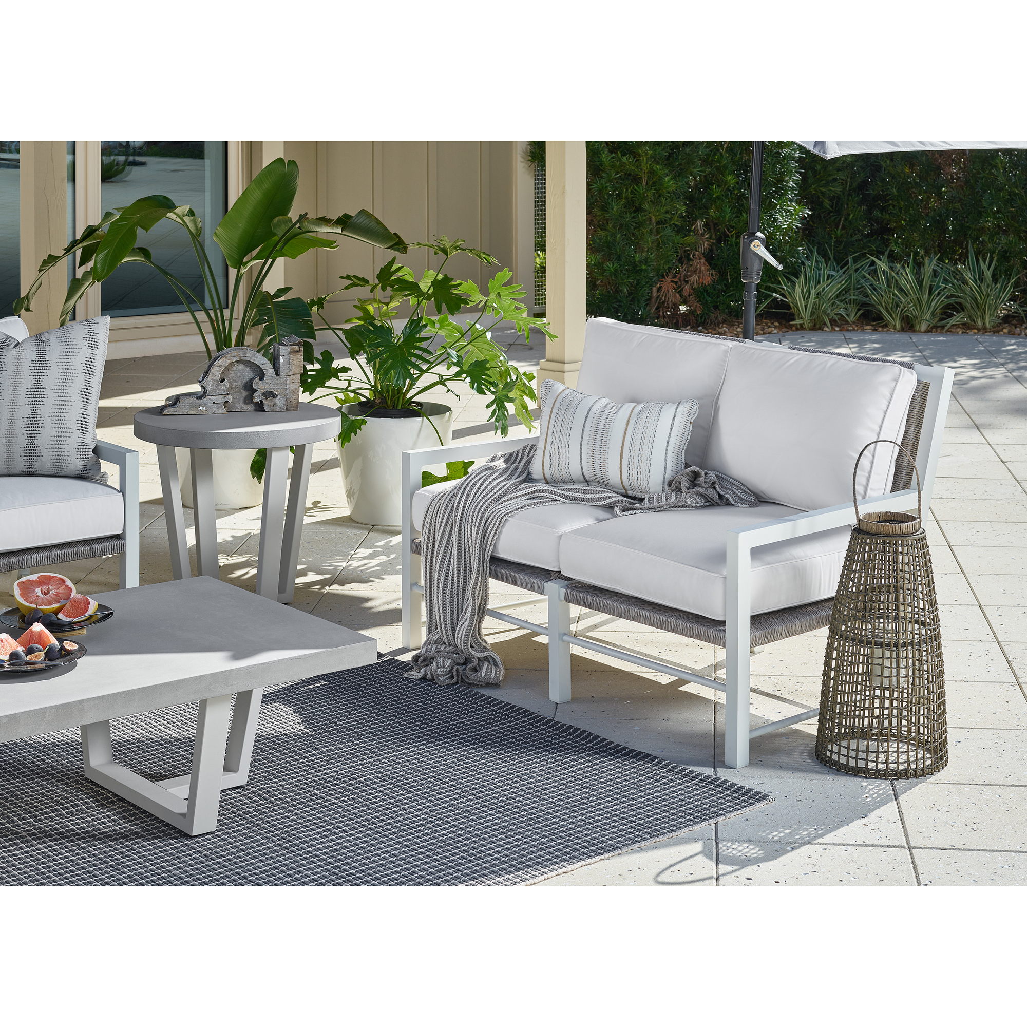 South Beach outdoor loveseat with Sunbrella cushions — included in the 7-piece Lux Seating Set