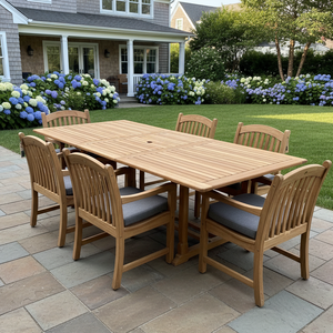 Bali Teak 7-piece outdoor dining set with rectangular extendable teak table and six Tista armchairs on a bluestone patio — view 2