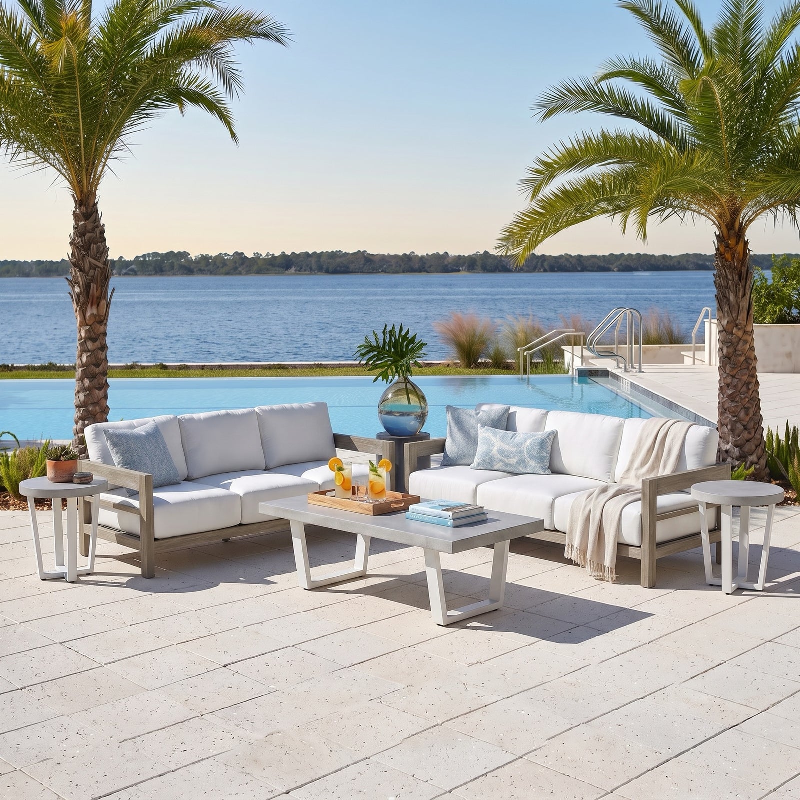 La Jolla Grand Lux 5-piece patio set styled on a poolside coastal patio - two teak sofas, stone-top coffee table and two end tables