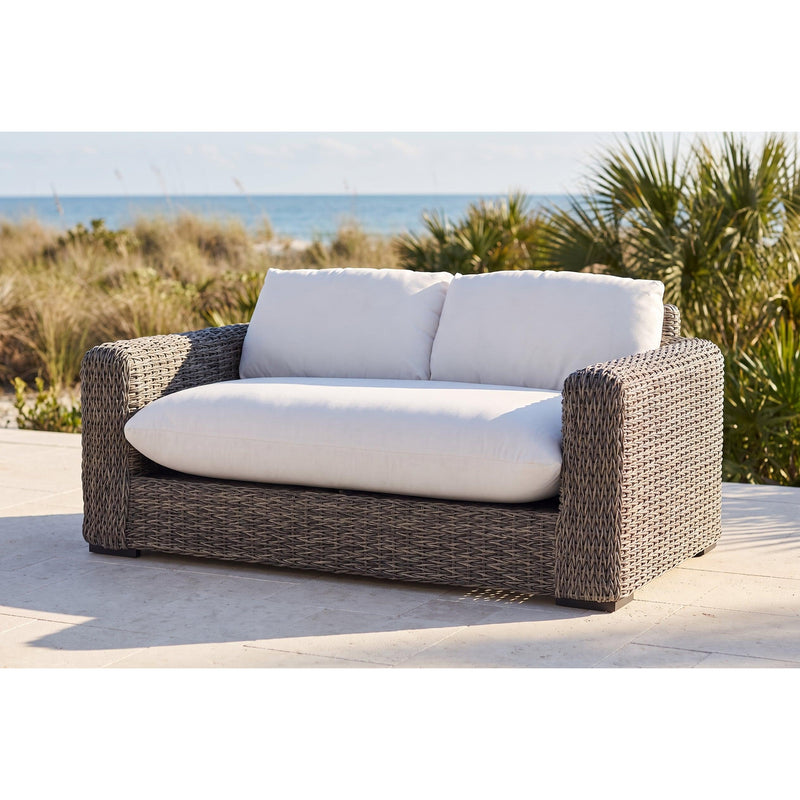 Montauk woven outdoor loveseat on a coastal patio