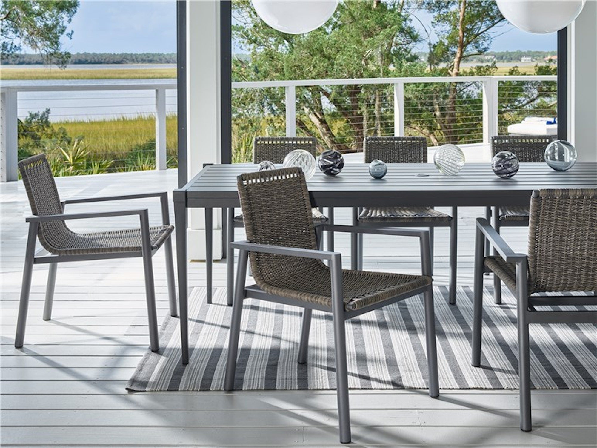 Panama Dining Chairs around a rectangular table on a coastal deck