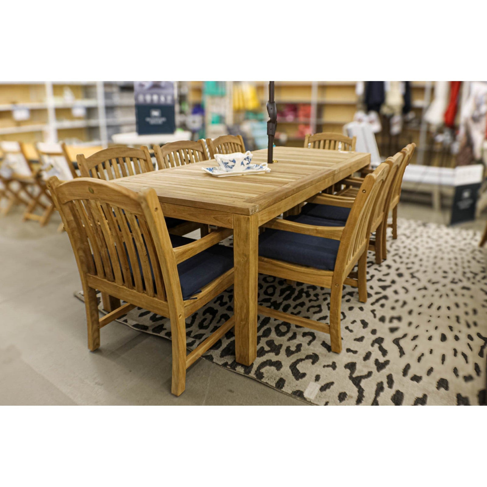 Tista Teak Armchairs with Navy cushions around teak dining table