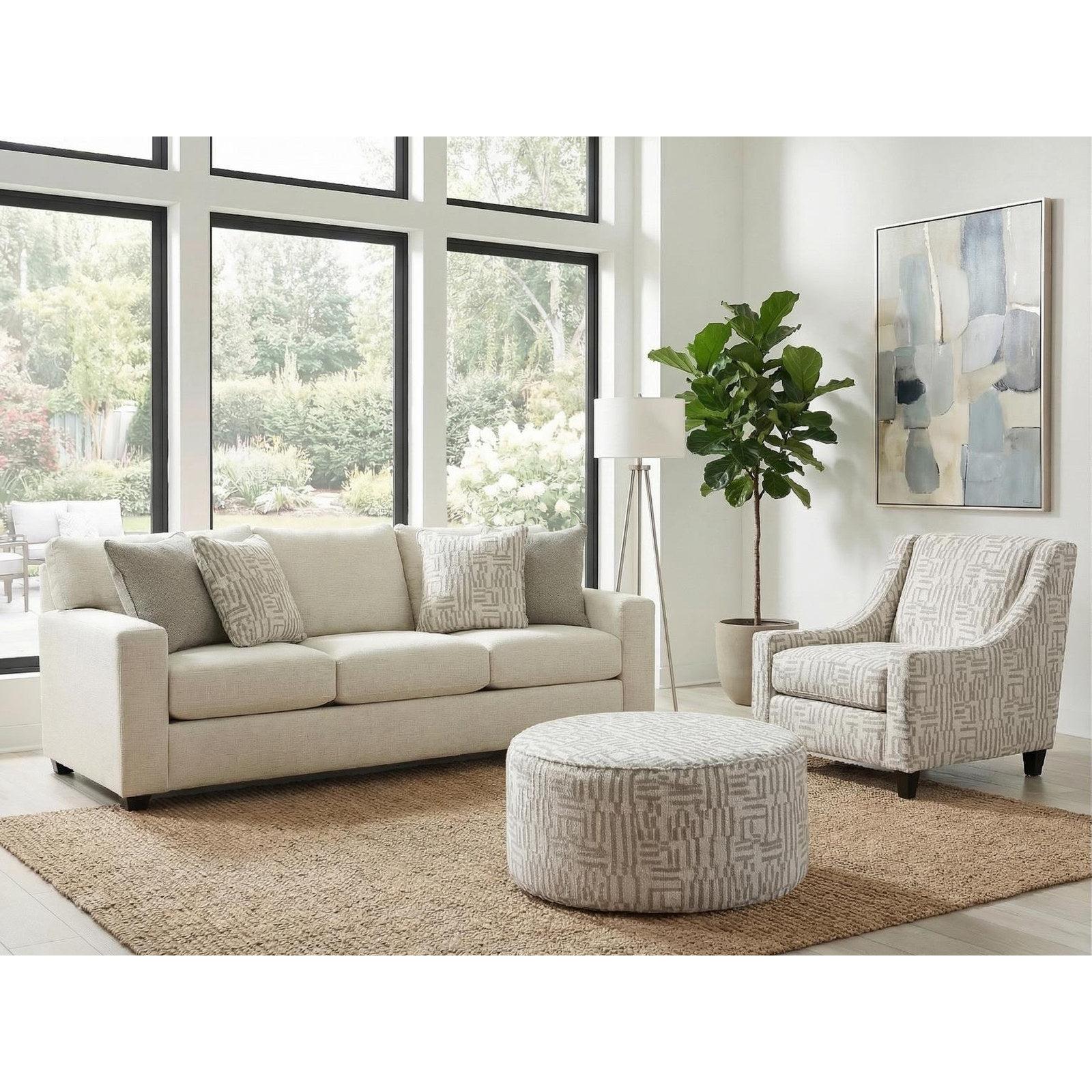 Sag Harbor Pearl track-arm sofa with a matching printed accent chair and round cocktail ottoman in a sunlit room
