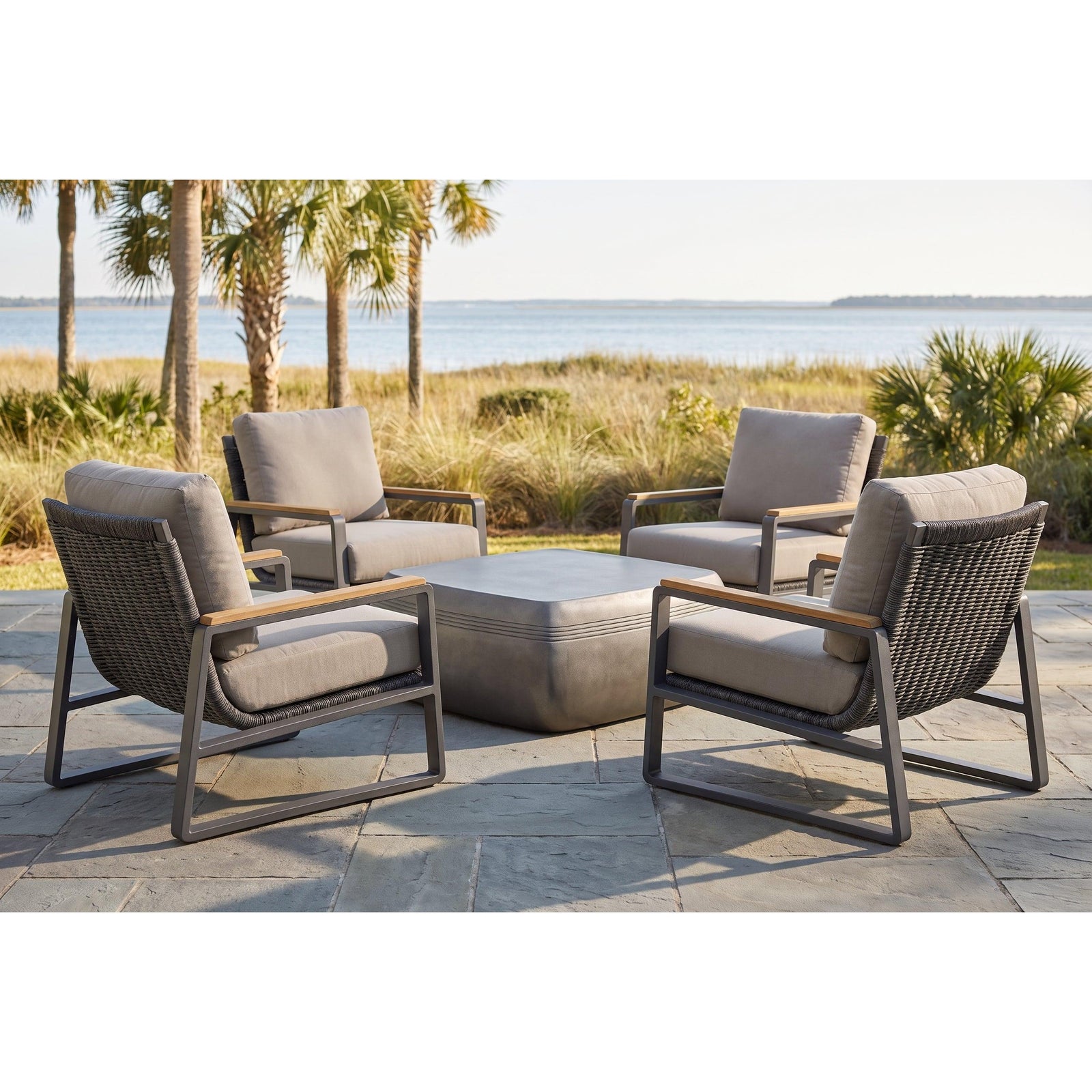 San Clemente 5-piece teak accent chat set — four lounge chairs around the Saratoga cocktail table on a coastal patio