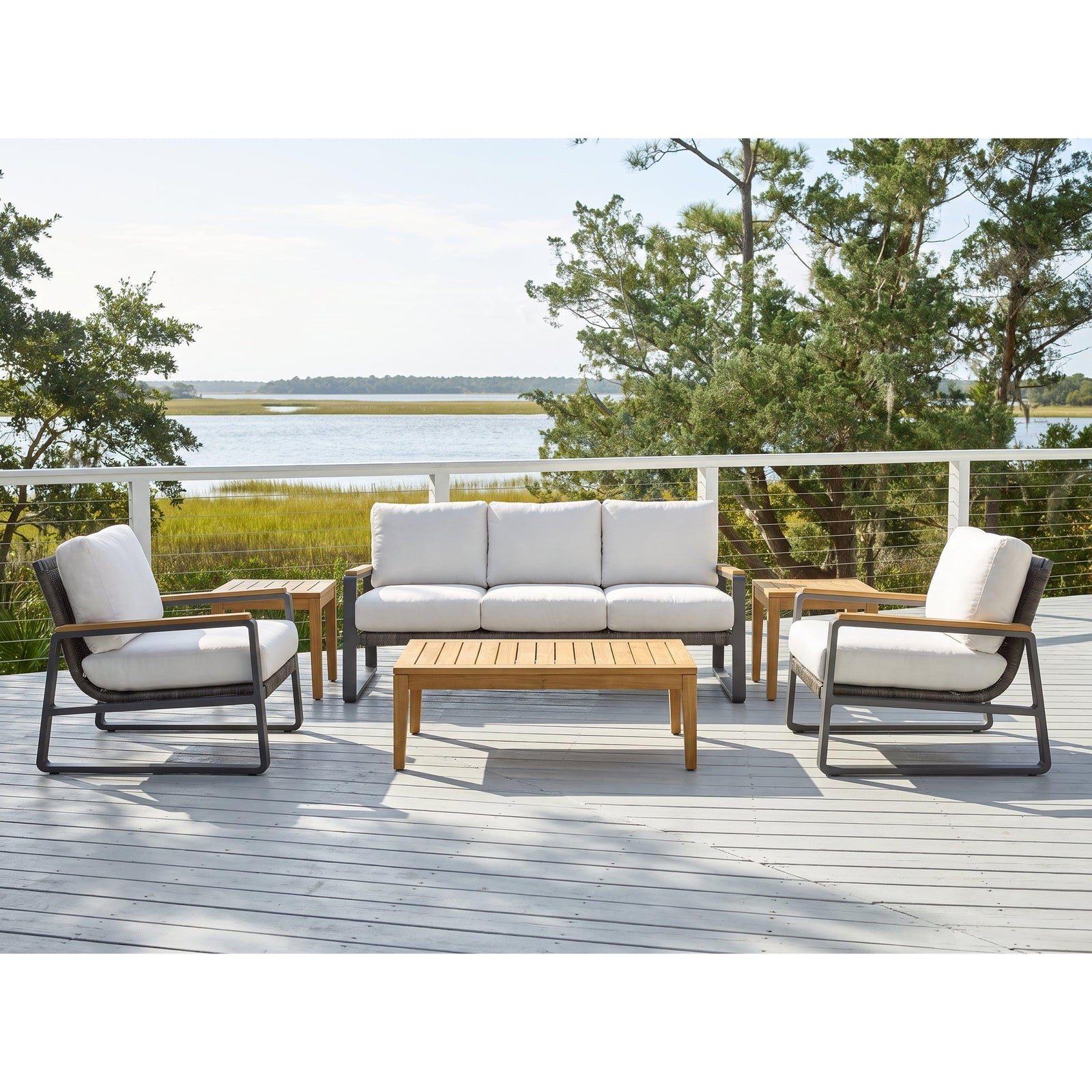 San Clemente 6-piece teak chat set — sofa, two club chairs and free Karimun teak coffee and side tables on a coastal deck