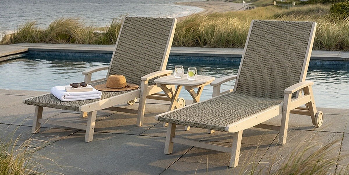 POLYWOOD Coastal Woven chaise lounges in sand with dune grass weave, set out on a beach